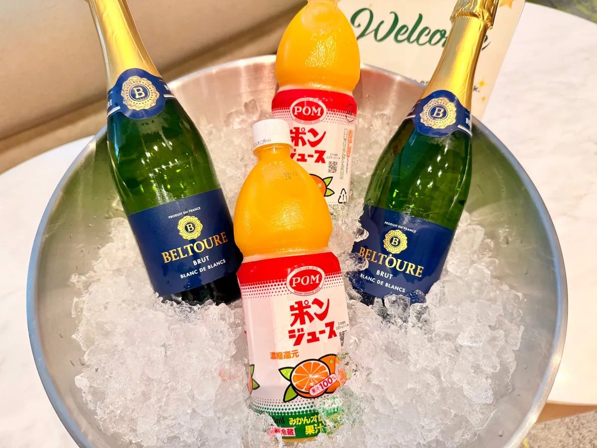 氷で冷やされたスパークリングワインとポンジュースのボトル