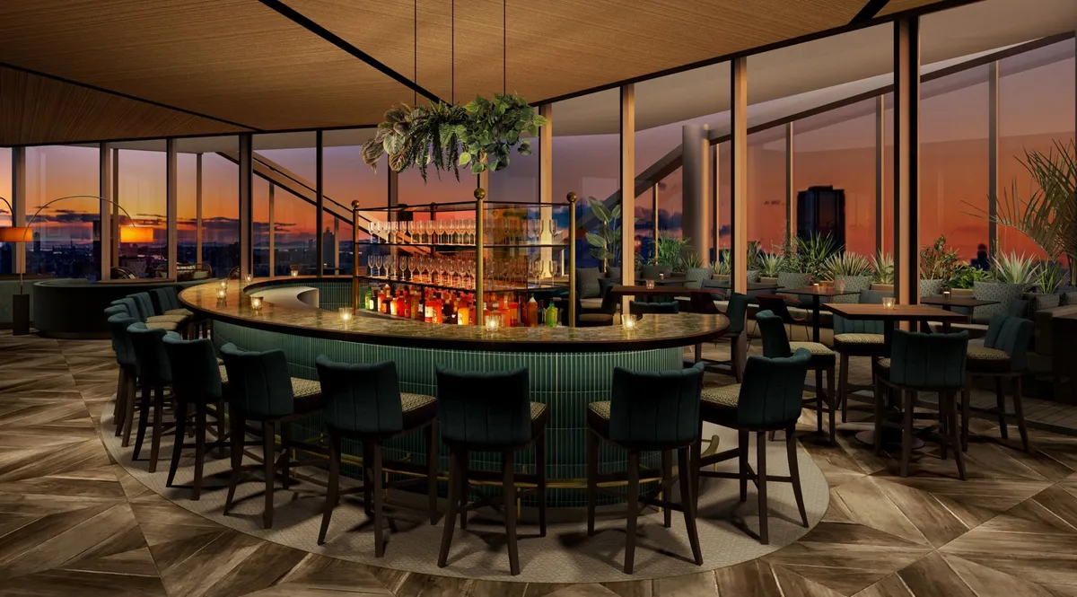 エメラルドグリーンの円形バーカウンターと夕景