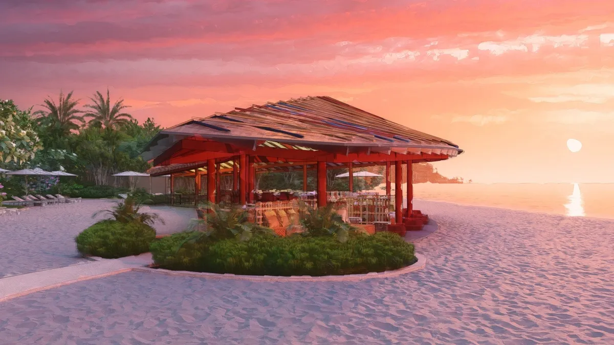 夕日に染まるビーチハウス。オレンジ色に輝く空と静かな海が織りなす幻想的な風景。